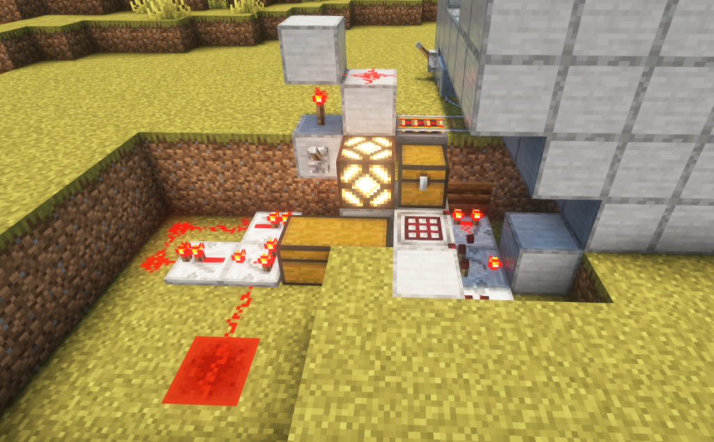 Minecraft crafter connected to hopper minecart collection system with full chest indicator